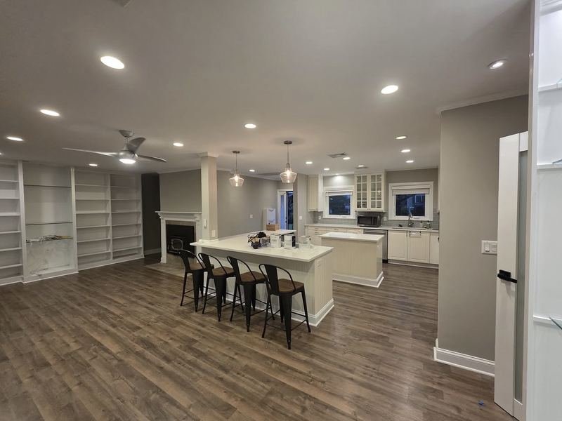 Open-concept kitchen and living area, painted with new flooring