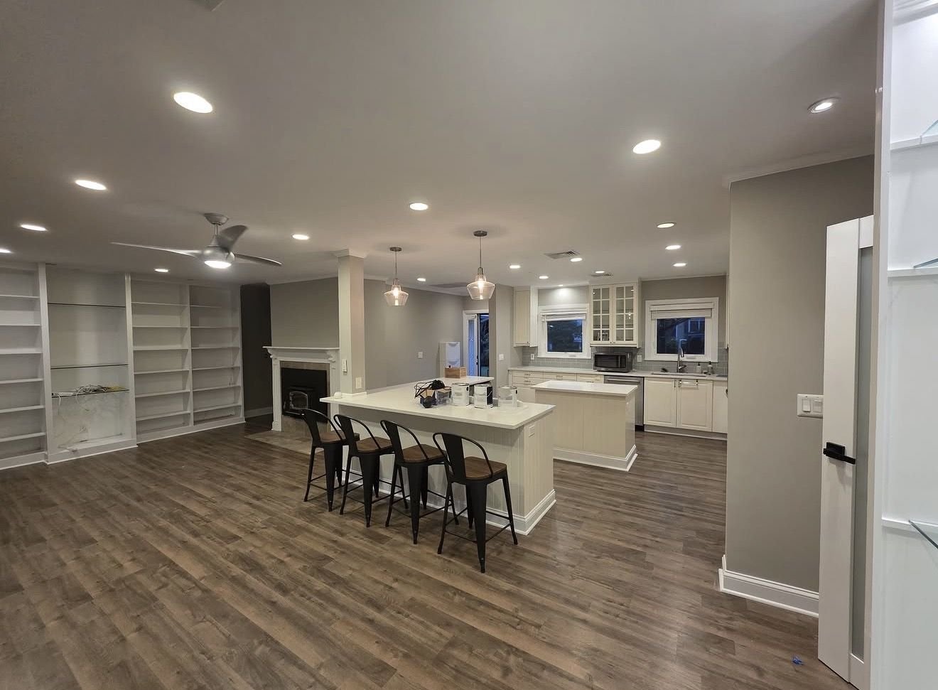 Open-concept kitchen and living area, painted with new flooring