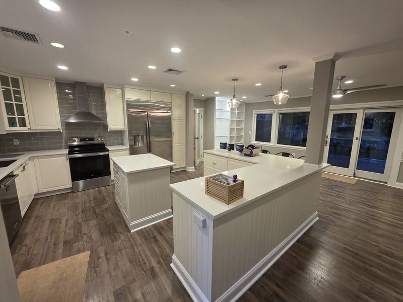 Kitchen with painted island and wood-look flooring