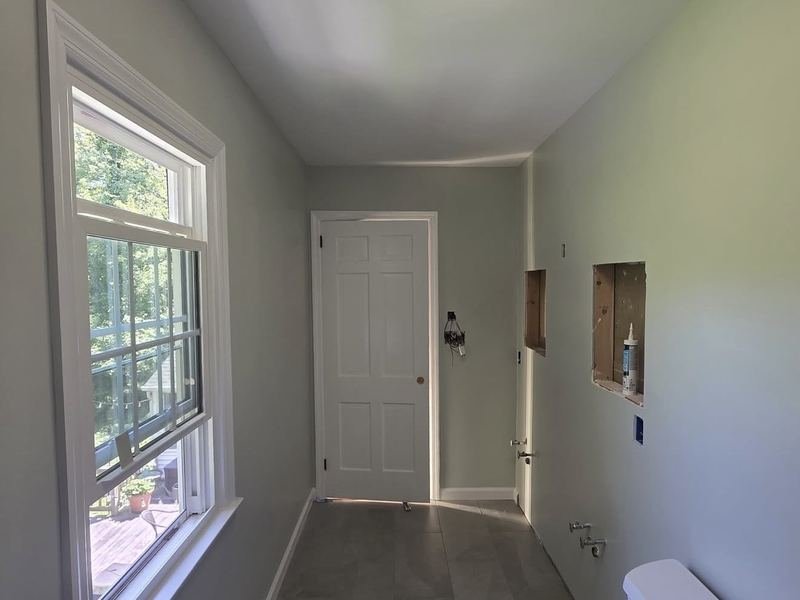 Renovated bathroom with fresh paint and tile floor