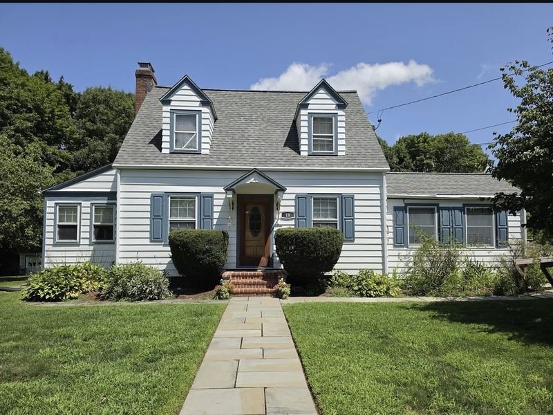 Cape Cod exterior repaint with blue shutters