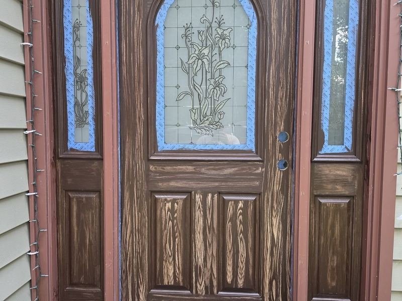 Entry door refinished in a rich wood-grain stain