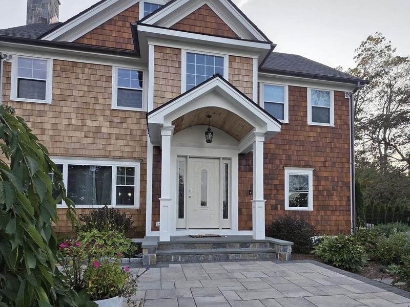 Cedar shingle home with crisp white trim and portico