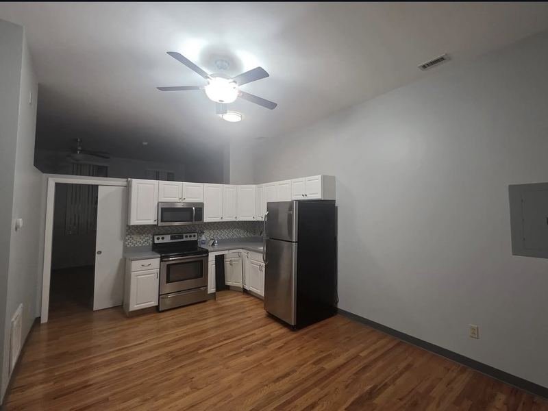 Kitchen and living area with refinished hardwood floors