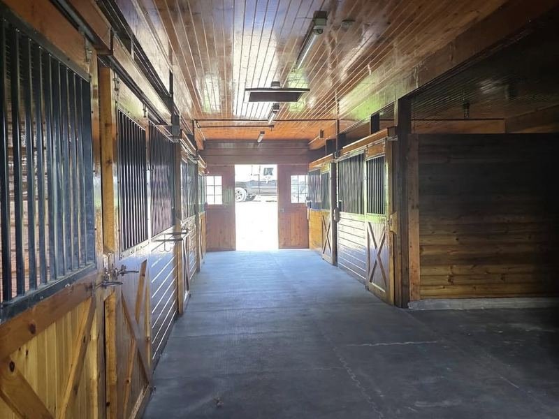 Barn interior with stained wood stalls and ceiling