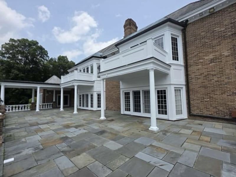 Covered porch with white columns and railings