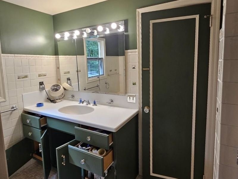 Bathroom vanity and door painted deep green